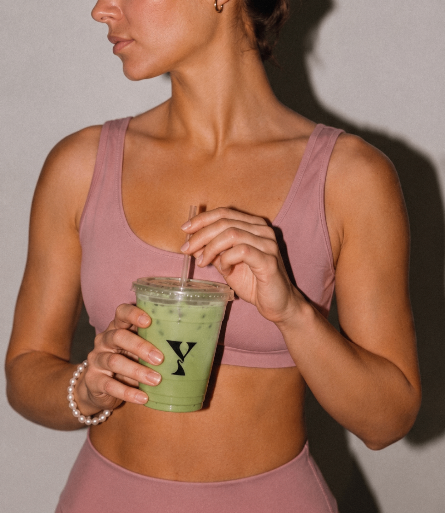 Lyne member with a matcha from the studio bar